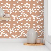 Pastel love hearts tossed hand drawn illustration pattern scandinavian style in soft ochre beige