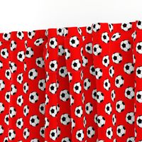 One Inch Black and White Soccer Balls on Red