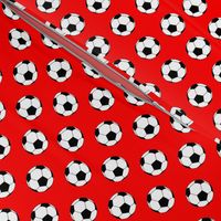 One Inch Black and White Soccer Balls on Red