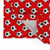 One Inch Black and White Soccer Balls on Red