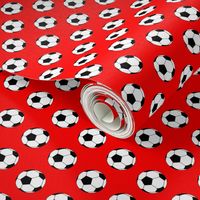 One Inch Black and White Soccer Balls on Red