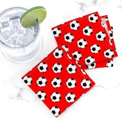 One Inch Black and White Soccer Balls on Red