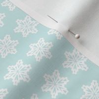 snowflakes in a pale blue sky