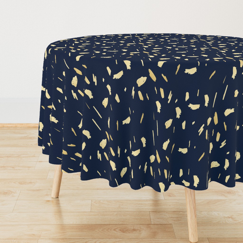 Gold paint blobs on navy blue