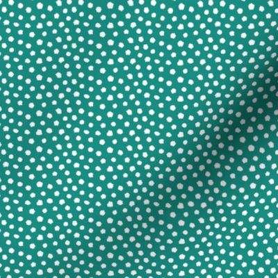 White spots on teal green