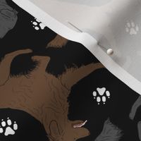 Trotting Flat coated Retrievers and paw prints - black