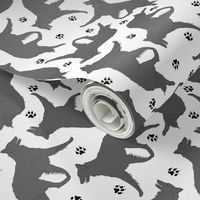 Trotting Belgian Sheepdog and paw prints - white