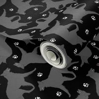 Trotting Belgian Sheepdog and paw prints - black
