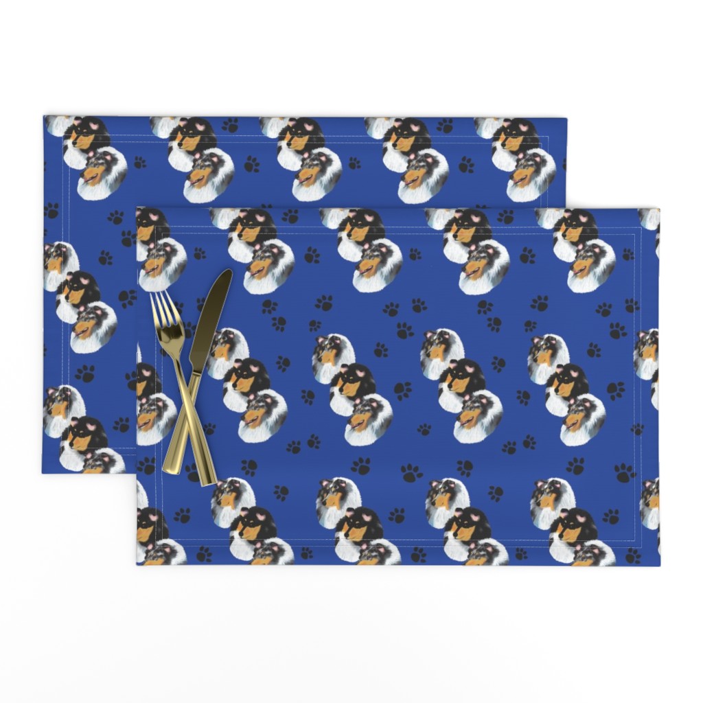 Collies with blue background with paw prints