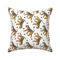 Trotting Airedale Terrier and paw prints - white