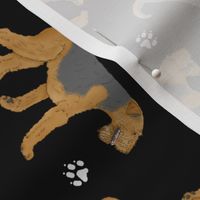 Trotting Airedale Terrier and paw prints - black