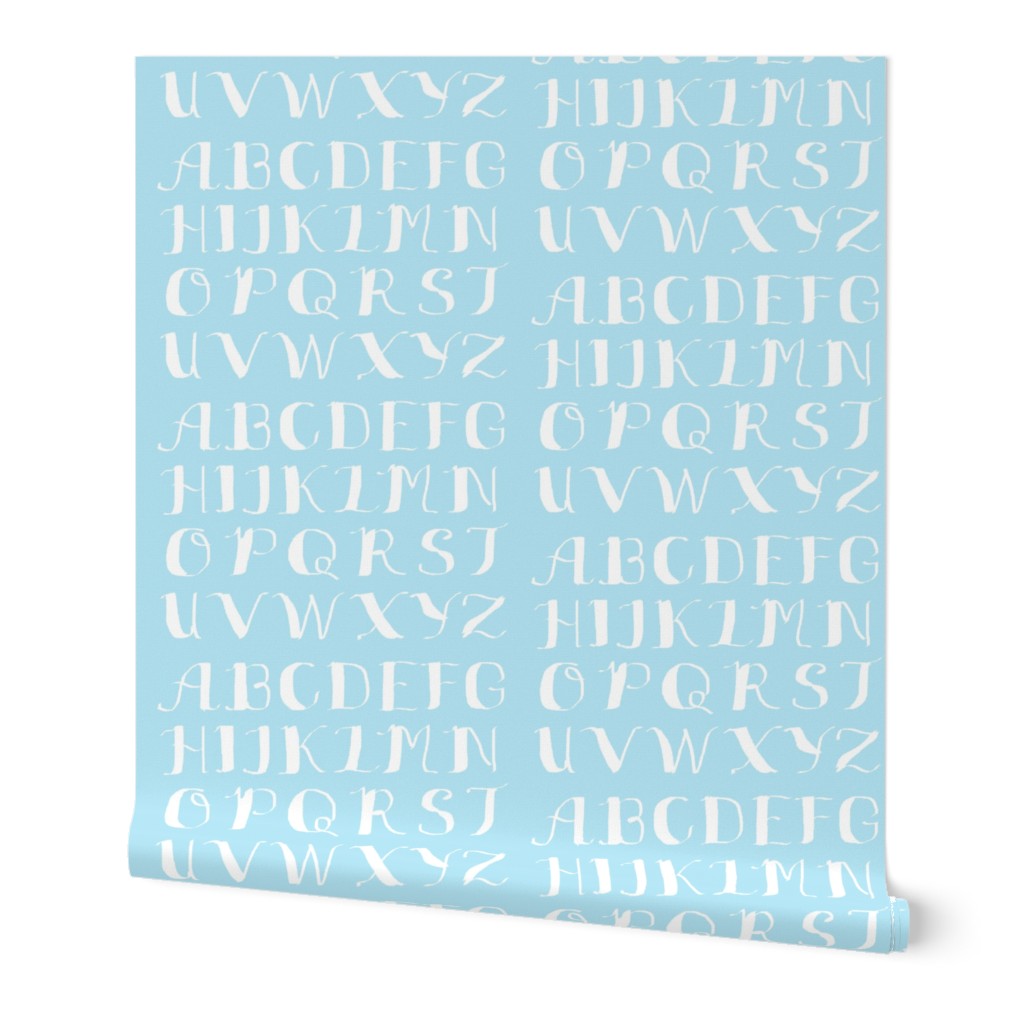 White Calligraphy Alphabet on Light Blue