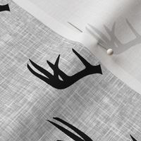 black antlers on light grey linen 