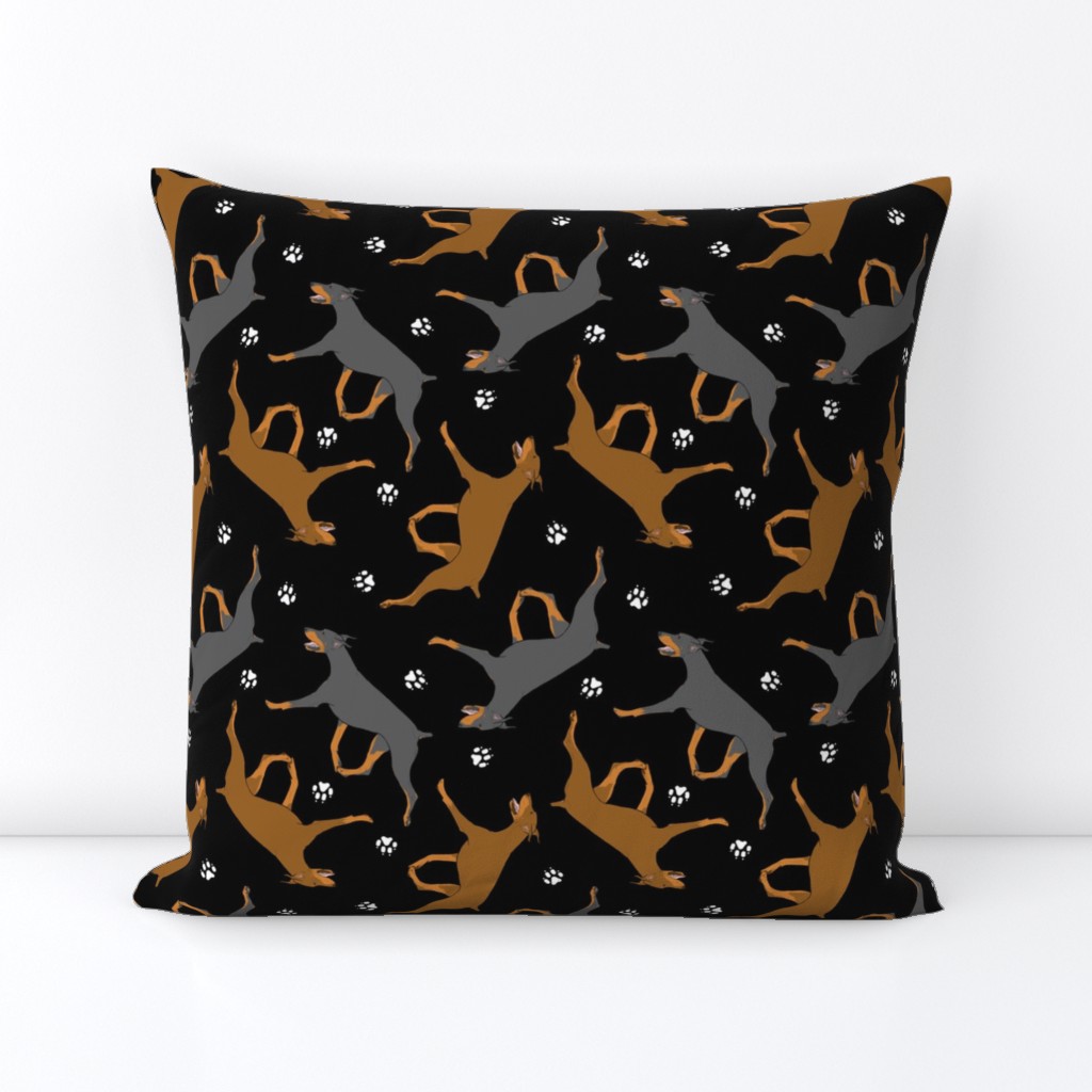 Trotting Doberman Pinschers and paw prints - black