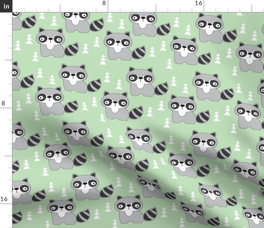 black and white raccoons on mint green