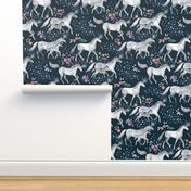 Mom and baby unicorns with stars on dark