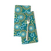 Sunny yellow and blue blooms on teal for a cheerful, retro-inspired look.