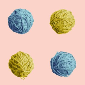 little blue and gold yarn balls on pink