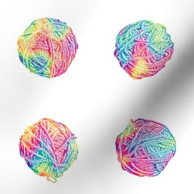 little tie-dyed rainbow yarn balls on white