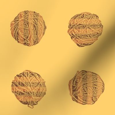 knitting in the morning:  self-striping yarn balls in copper and brown on gold