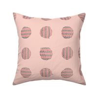 self-striping yarn balls in coral and grey on pink