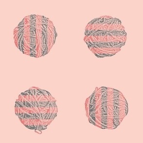 self-striping yarn balls in coral and grey on pink
