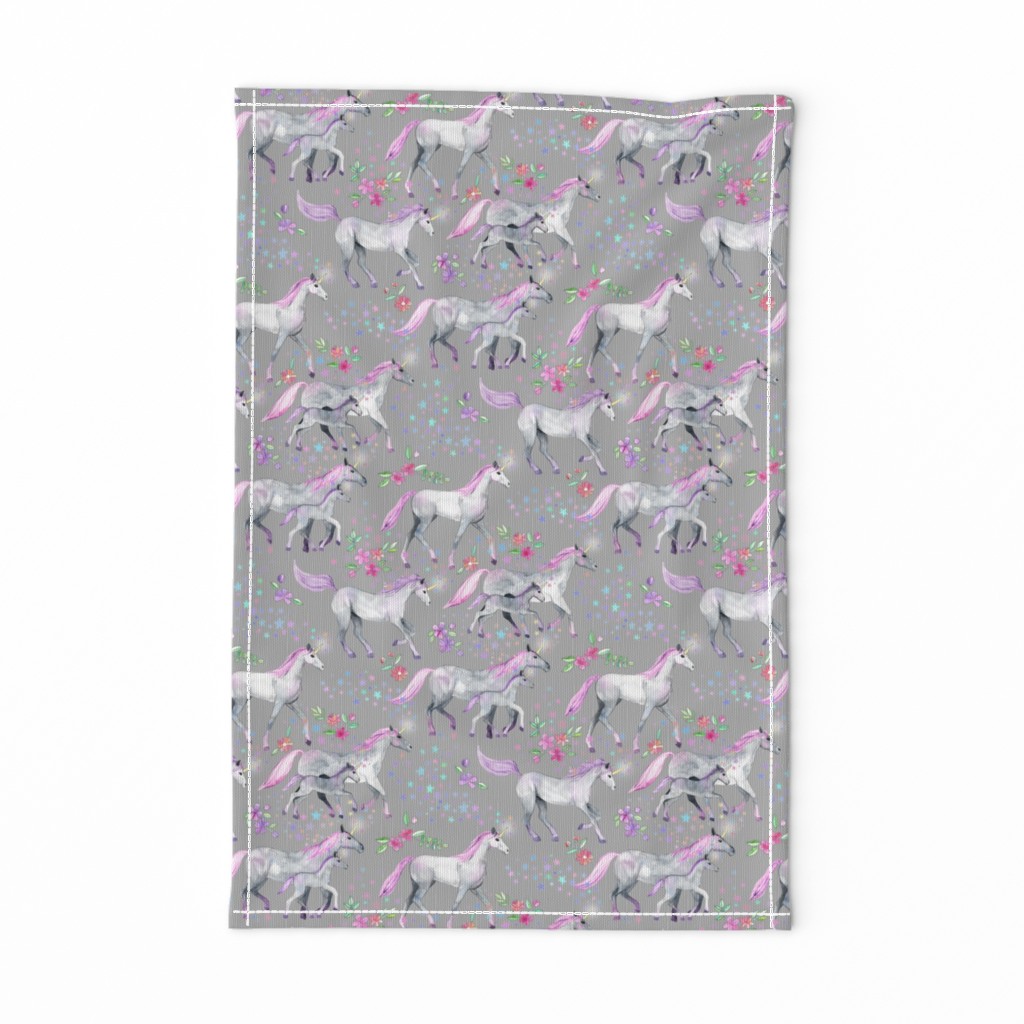 Mom and baby unicorns with pink and purple manes and tails on grey