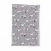 Mom and baby unicorns with pink and purple manes and tails on grey