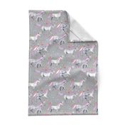 Mom and baby unicorns with pink and purple manes and tails on grey