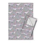 Mom and baby unicorns with pink and purple manes and tails on grey