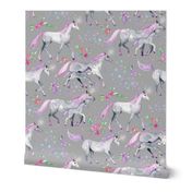 Mom and baby unicorns with pink and purple manes and tails on grey