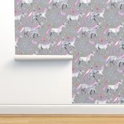 Mom and baby unicorns with pink and purple manes and tails on grey
