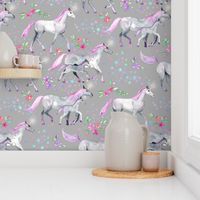 Mom and baby unicorns with pink and purple manes and tails on grey