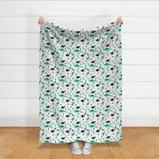 Adorable dino boys fabric with black and green dinosaur geometric triangles and funky animal illustration theme for kids