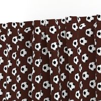 One Inch Black and White Soccer Balls on Brown