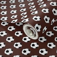 One Inch Black and White Soccer Balls on Brown