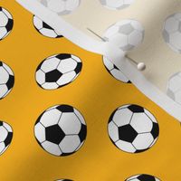 One Inch Black and White Soccer Balls on Yellow Gold