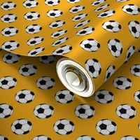 One Inch Black and White Soccer Balls on Yellow Gold