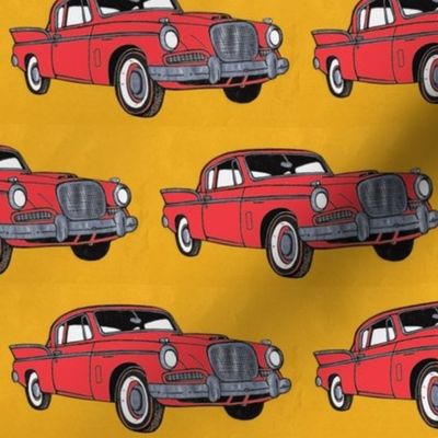 Big red finned 1957 Studebaker Hawk on gold background