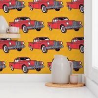 Big red finned 1957 Studebaker Hawk on gold background