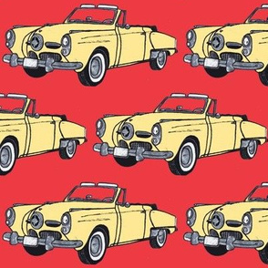 big cream yellow 1950 Studebaker convertible bullit nose on red