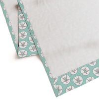 sand dollars on light teal