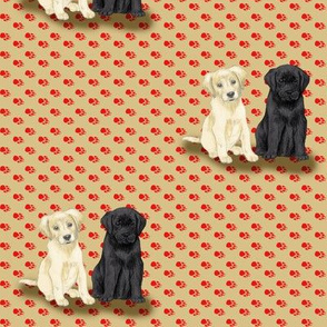 Two Sitting Labrador Retriever Puppies on Red Pawprints