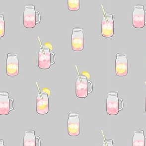 pink lemonade w/ straws - summer time drinks on grey  