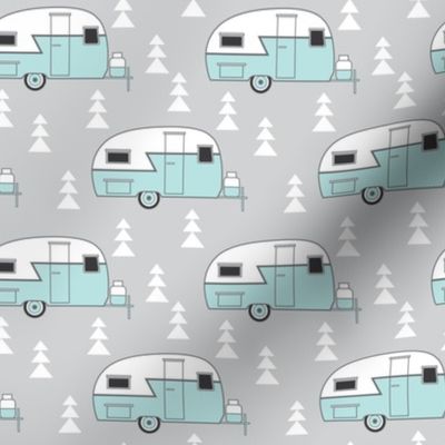 small teal vintage trailer on grey