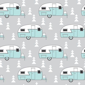 small teal vintage trailer on grey