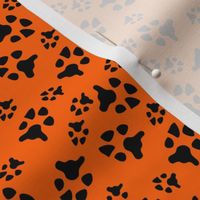 paw prints black on orange