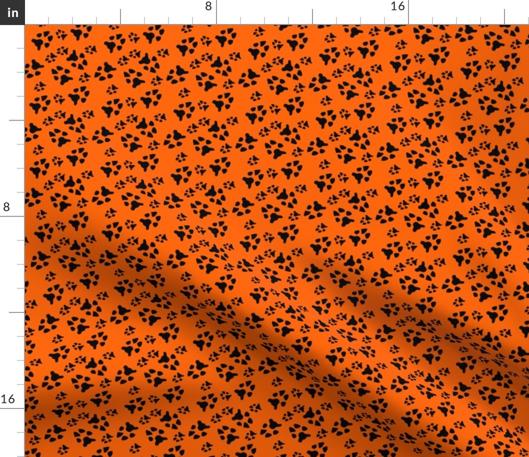 paw prints black on orange