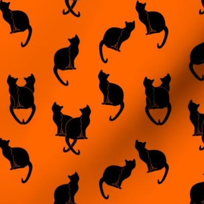 black cats silhouettes on orange