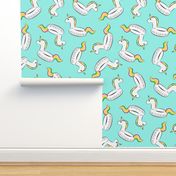 unicorn pool float toss on light teal